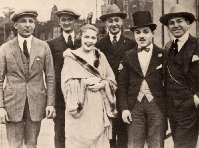 From left: Film producer Sam Warner, exhibitor Joe Marks from Youngstown, Ohio, actress Florence Gilbert, racing pilot Art Klein, comic actor Monty Banks, and film producer Jack Warner. From page 82 of the Feb. 28, 1920 Exhibitors Herald. (Image courtesy of Wikimedia)