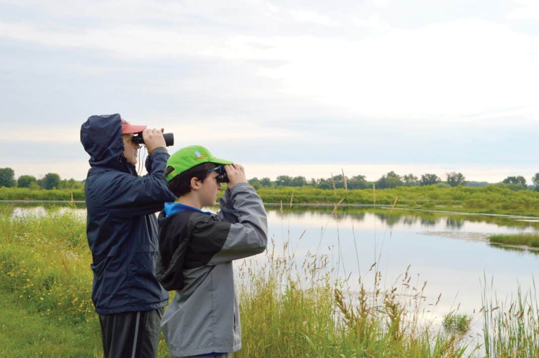 MetroParks to offer walks, hikes, nature explorations. This picture depicts two people observing wildlife at the Mill Creek Wildlife Sanctuary in Canfield. Mill Creek Metroparks will host Birding the Sanctuary on July 19 and Aug. 16 at the Mill Creek Wildlife Sanctuary, 2650 W. Calla Road, Canfield 44406. Call 330-702-3000 for more information or visit millcreekmetroparks.org. Image courtesy of Mill Creek MetroParks