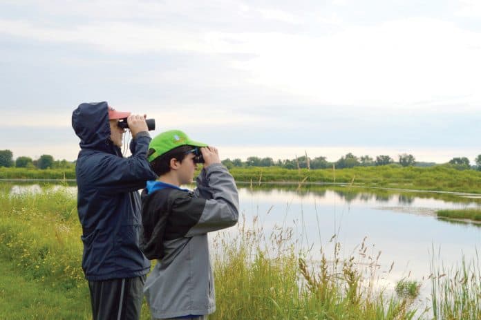 WEB Birding the Sanctuary 4-23 MetroParks to offer walks, hikes, nature explorations. This picture depicts two people observing wildlife at the Mill Creek Wildlife Sanctuary in Canfield. Mill Creek Metroparks will host Birding the Sanctuary on July 19 and Aug. 16 at the Mill Creek Wildlife Sanctuary, 2650 W. Calla Road, Canfield 44406. Call 330-702-3000 for more information or visit millcreekmetroparks.org. Image courtesy of Mill Creek MetroParks