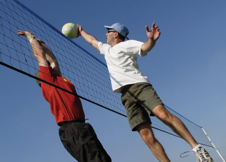 Summer sports, league play, camps around the Mahoning Valley. Photo depicts adult men playing volleyball outdoors. This article shows where to find recreational activities for children, youth, adults and families in Youngstown, Warren and the greater Mahoning Valley. Image by Can Stock