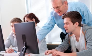 Picture depicts a young man receiving computer instruction during a group class. Area libraries will offer free computer classes this summer. Programs include computer education, apps, technology and internet safety. Classes are free, but registration is required. Picture is a Can Stock image.