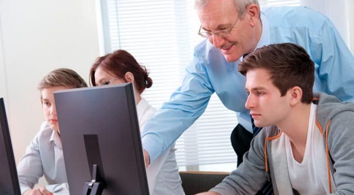 Picture depicts a young man receiving computer instruction during a group class. Area libraries will offer free computer classes this summer. Programs include computer education, apps, technology and internet safety. Classes are free, but registration is required. Picture is a Can Stock image.
