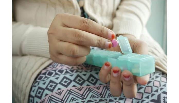 Web Penn State substance abuse webinars This image depicts a woman picking up a pill from a pill carrier. Penn State to offer webinars on substance-use education.