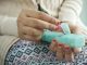 This image depicts a woman picking up a pill from a pill carrier. Penn State to offer webinars on substance-use education.